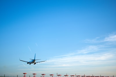 white airplane flying during daytime